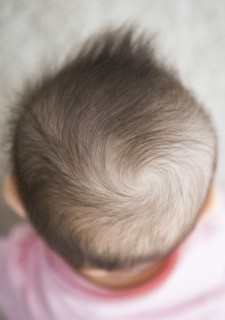 Close up of mixed race baby girl's hair