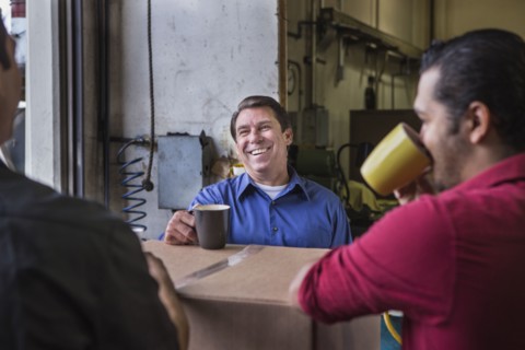 Workers enjoying coffee break in warehouse