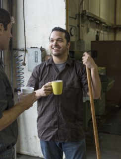Workers having coffee together in warehouse
