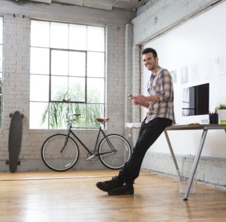 Caucasian architect using cell phone in office