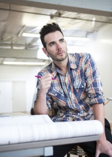 Caucasian architect designing blueprints in office