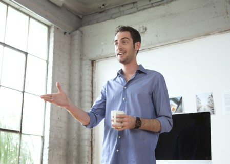 Caucasian architect drinking coffee in office