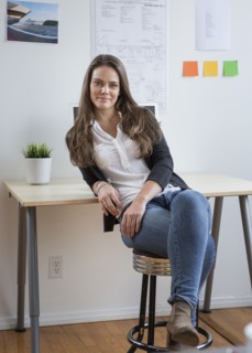 Caucasian architect smiling in office