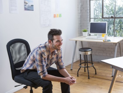 Caucasian architect smiling in office