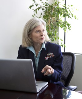 Caucasian businesswoman talking at desk