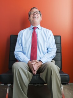 Caucasian businessman laughing in chair