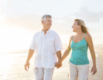 Caucasian couple walking on beach