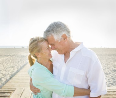 Caucasian couple hugging on beach
