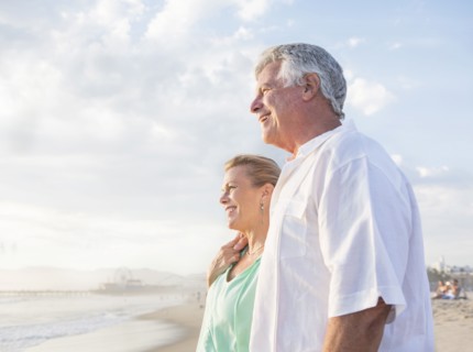 Caucasian couple hugging on beach