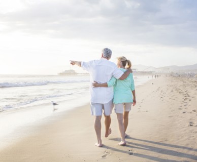 Caucasian couple walking on beach