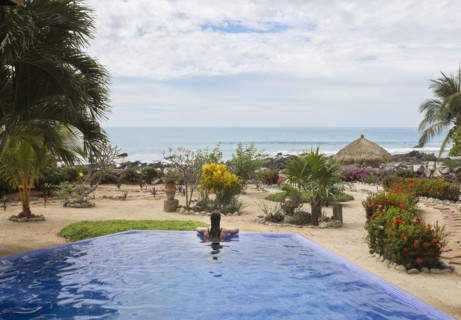 Hispanic woman relaxing in swimming pool