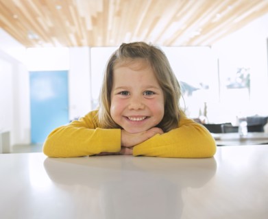 Caucasian girl smiling on counter