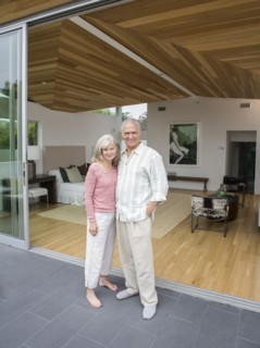 Older Caucasian couple smiling on porch
