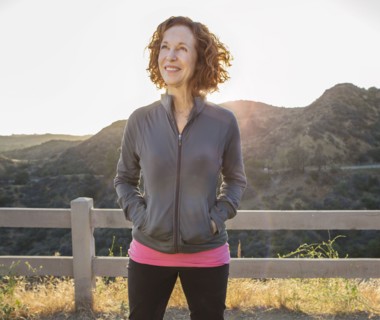Caucasian woman smiling on hilltop