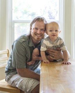Caucasian father and son smiling at table