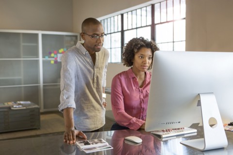 Business people using computer in office
