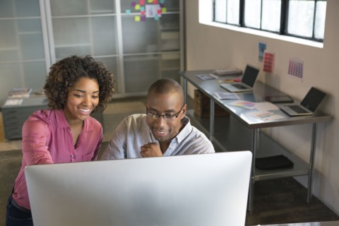 Business people using computer in office