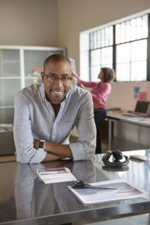Businessman smiling at desk in office