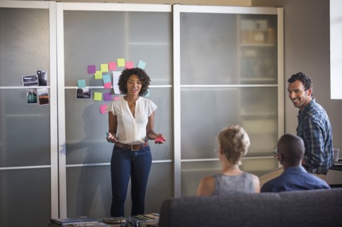 Businesswoman talking to colleagues in office meeting