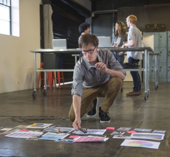 Caucasian businessman examining paperwork on office floor