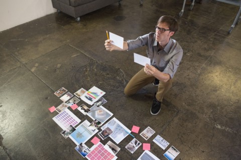Caucasian businessman examining paperwork on office floor