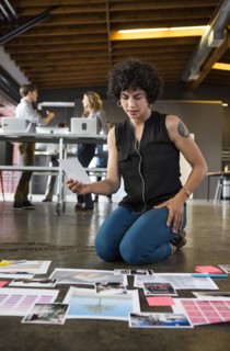 Businesswoman examining paperwork on office floor