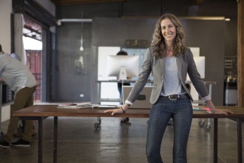 Caucasian businesswoman smiling in office