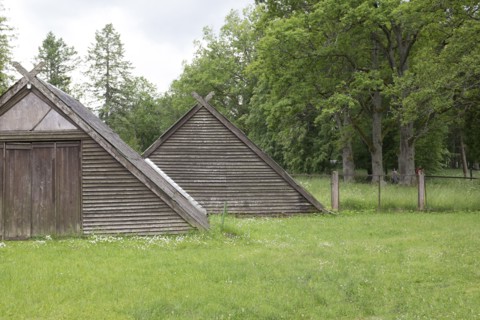 Traditional wooden buildings in field