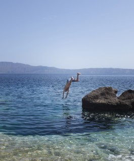 Caucasian man diving into ocean