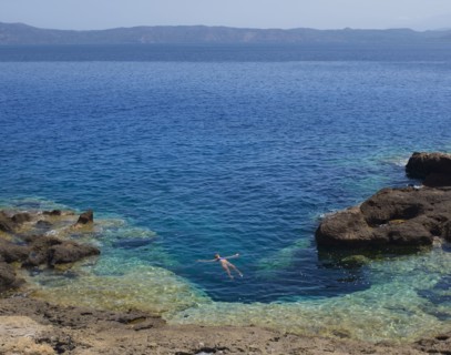 Hispanic woman floating in ocean