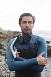 Hispanic diver wearing snorkel mask