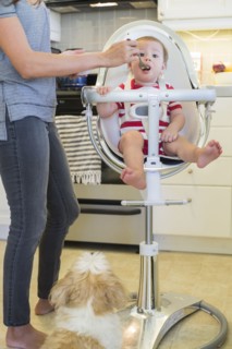 Mixed race mother feeding baby outdoors