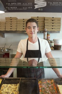 Server smiling in cafe