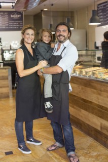 Caucasian family business owners smiling in cafe