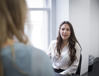 Caucasian businesswomen talking in office