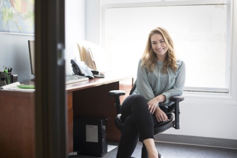 Caucasian businesswoman smiling in office