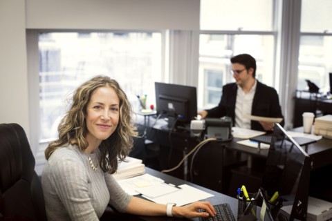 Caucasian businesswoman smiling in office