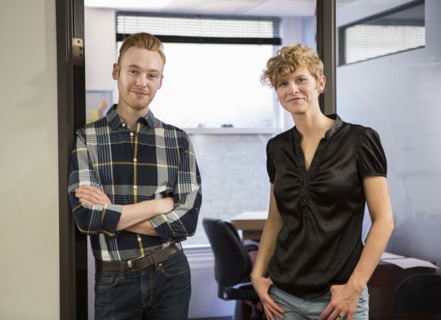 Caucasian business people smiling in office doorway