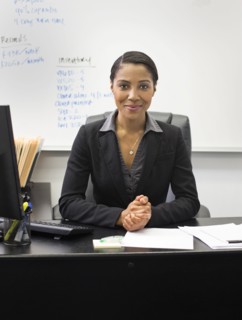 African American businesswoman sitting at desk in office