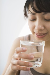 Hispanic woman drinking water