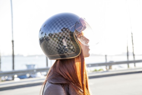 Caucasian woman wearing motorcycle helmet