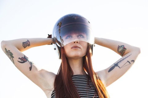 Caucasian woman wearing motorcycle helmet