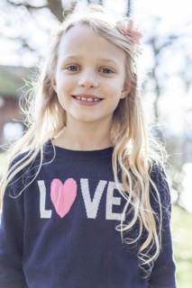 Smiling girl wearing love sweater
