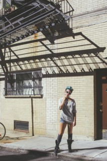 Caucasian woman standing on city sidewalk