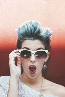 Surprised Caucasian woman with sunglasses and dyed hair