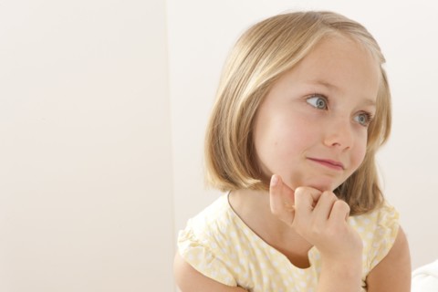 Caucasian girl resting chin in hand