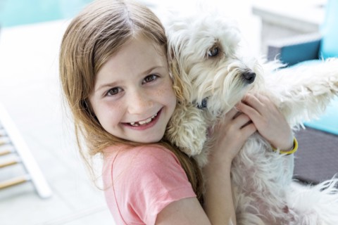 Close up of Caucasian girl hugging puppy