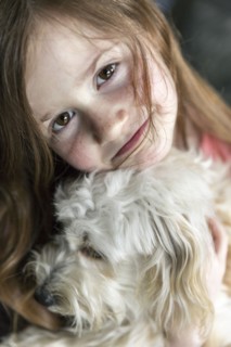 Close up of Caucasian girl hugging puppy