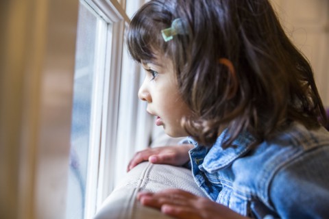 Close up of girl looking out window