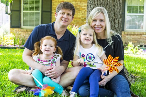 Caucasian family smiling in backyard